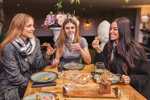 group-of-female-friends-eating-at-restaurant