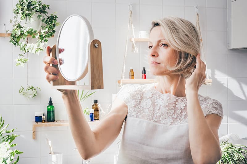 middle-aged-woman-looking-in-the-mirror