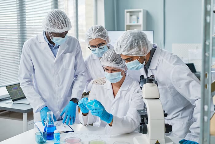 scientists-examining-sample-in-team